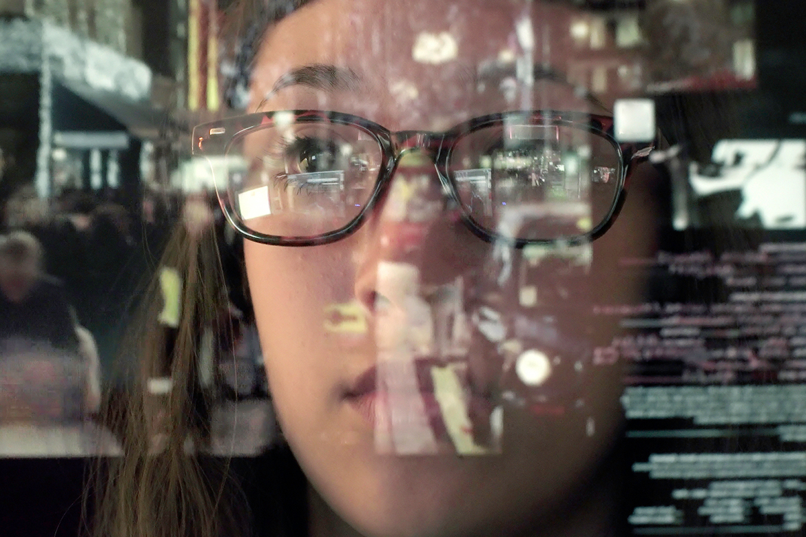 woman staring thru glass screen