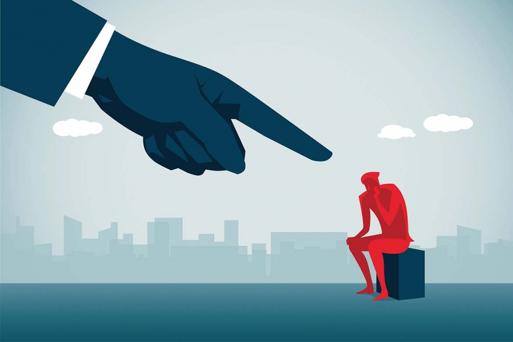 Big pointing finger at seated figure