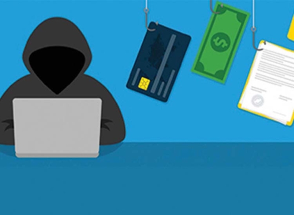 hooded person at laptop